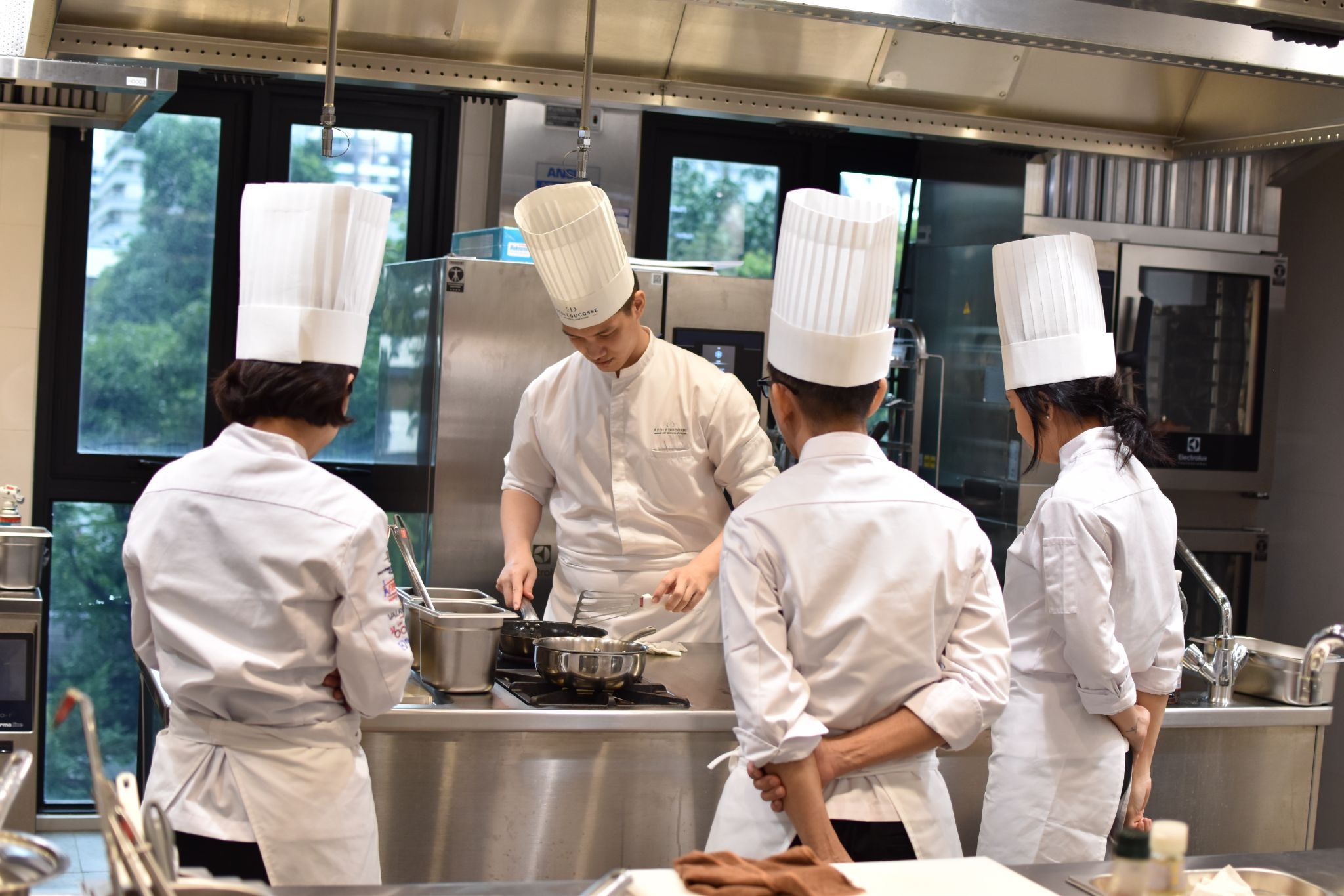 Professional chefs in culinary training kitchen Bangkok