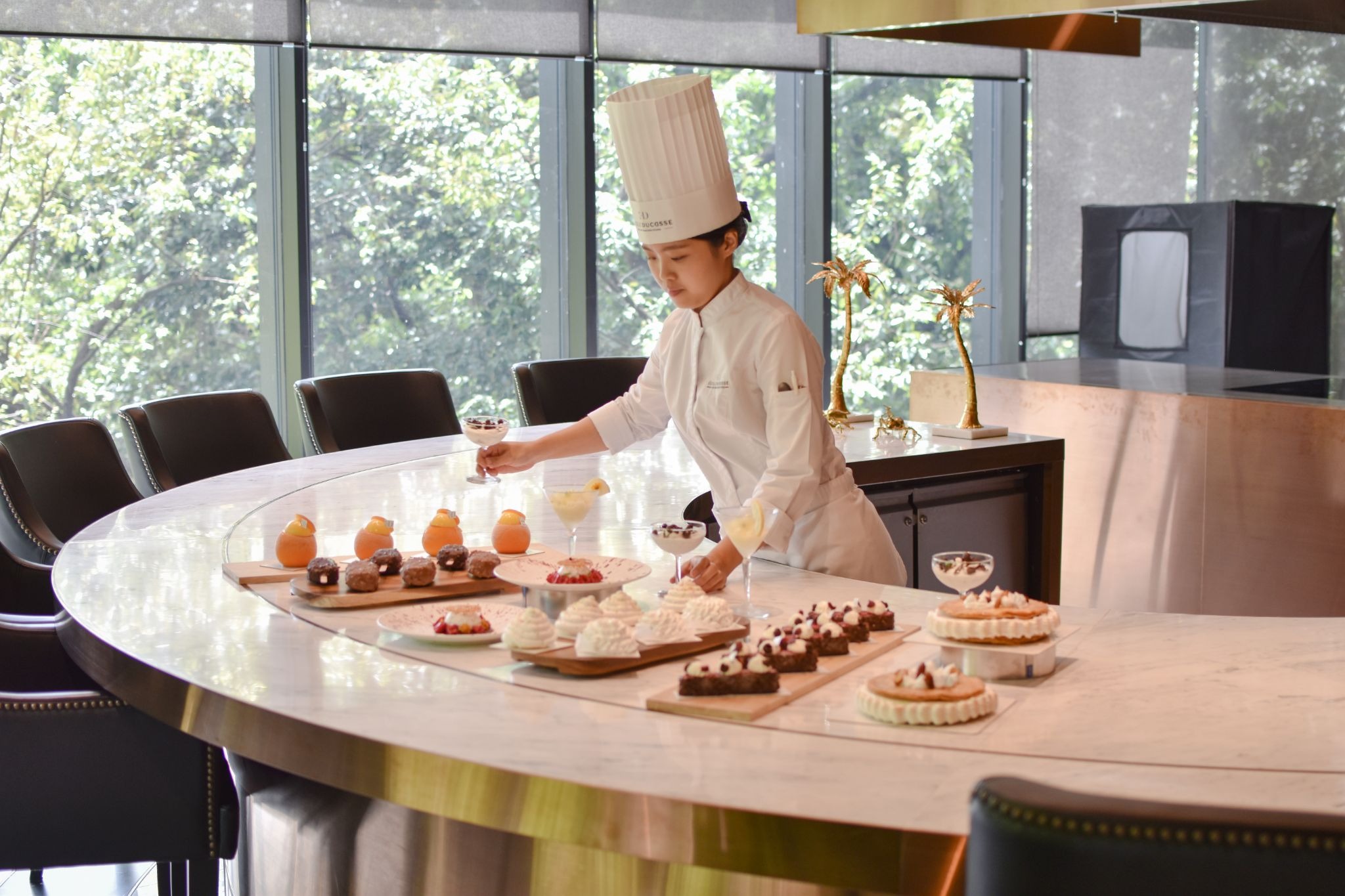 Pastry chefs making desserts in professional kitchen
